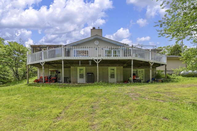 rear view of property with central AC, a wooden deck, and a yard