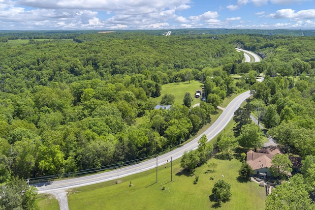 birds eye view of property featuring a view of trees