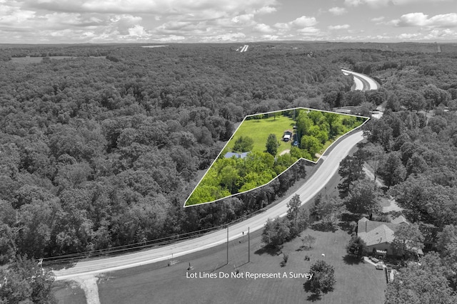 birds eye view of property featuring a view of trees