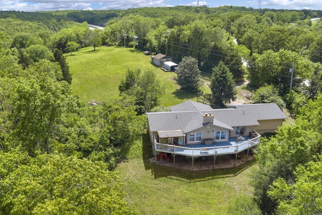 bird's eye view with a wooded view