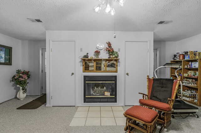 335 State Highway 265, Hollister, MO 65672 - sitting room featuring a textured ceiling, a glass covered fireplace, and carpet