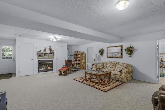 335 State Highway 265, Hollister, MO 65672 - carpeted living room with a textured ceiling and a fireplace with flush hearth