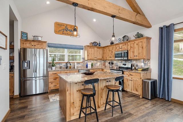 kitchen featuring stainless steel appliances, a center island, a sink, backsplash, and high vaulted ceiling