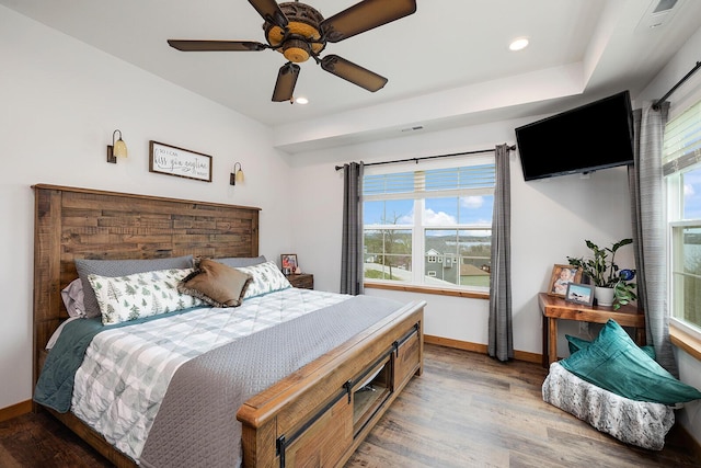 bedroom with recessed lighting, light wood-type flooring, and baseboards