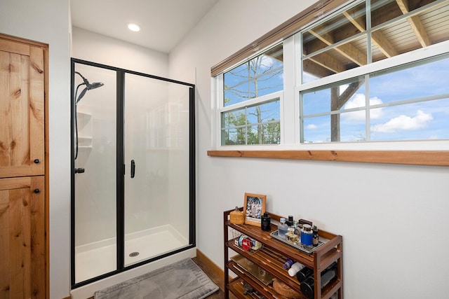 bathroom featuring recessed lighting, baseboards, and a stall shower