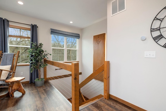 interior space featuring baseboards, wood finished floors, visible vents, and recessed lighting