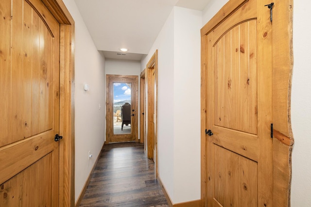 hallway with baseboards, dark wood-type flooring, and recessed lighting
