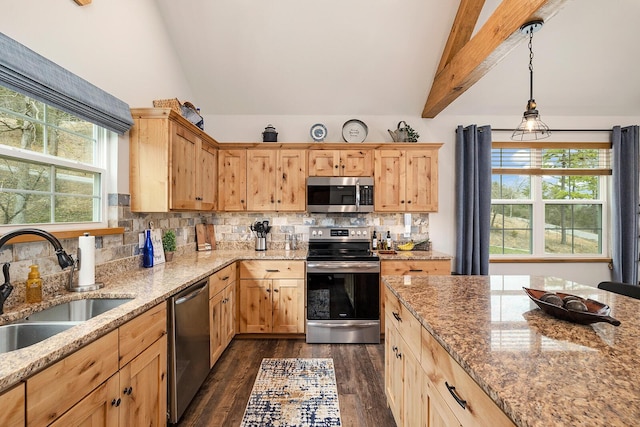 kitchen featuring light brown cabinets, a sink, vaulted ceiling with beams, stainless steel appliances, and dark wood-style flooring