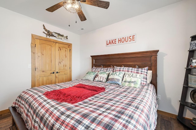 bedroom featuring visible vents, baseboards, a ceiling fan, and wood finished floors