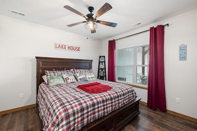 bedroom featuring baseboards, dark wood-type flooring, and visible vents