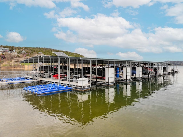 view of dock with boat lift and a water view