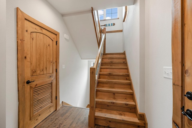 stairway with wood finished floors