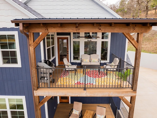 wooden terrace with an outdoor living space