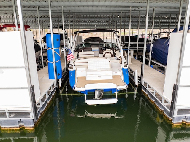 dock area featuring boat lift and a water view