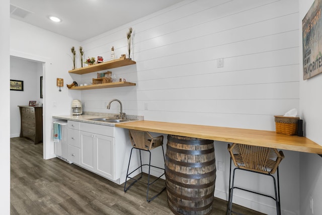 kitchen with white cabinets, open shelves, a sink, and dark wood-type flooring