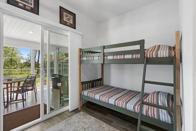 bedroom with wood finished floors and access to exterior