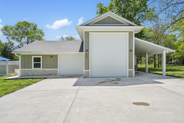view of front of house with concrete driveway, roof with shingles, stone siding, and board and batten siding
