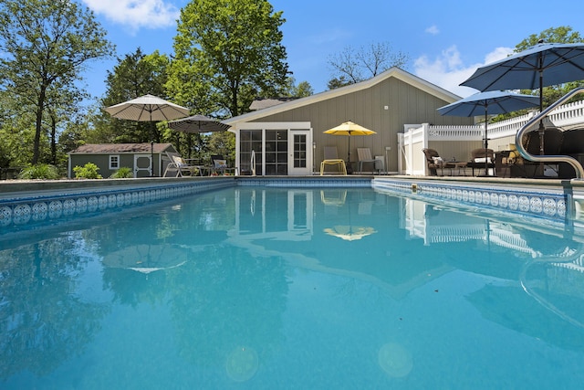pool with an outbuilding and fence