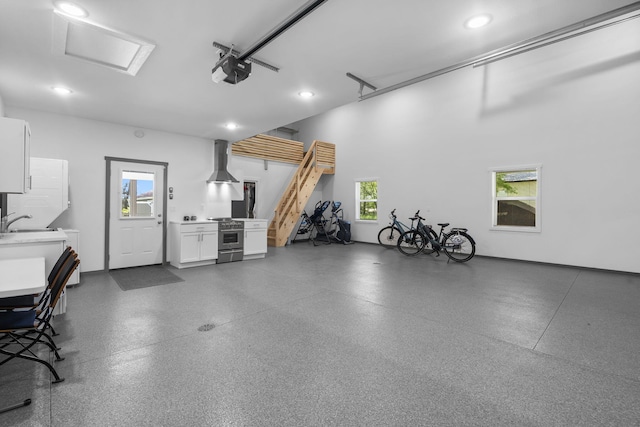 garage featuring a sink and recessed lighting