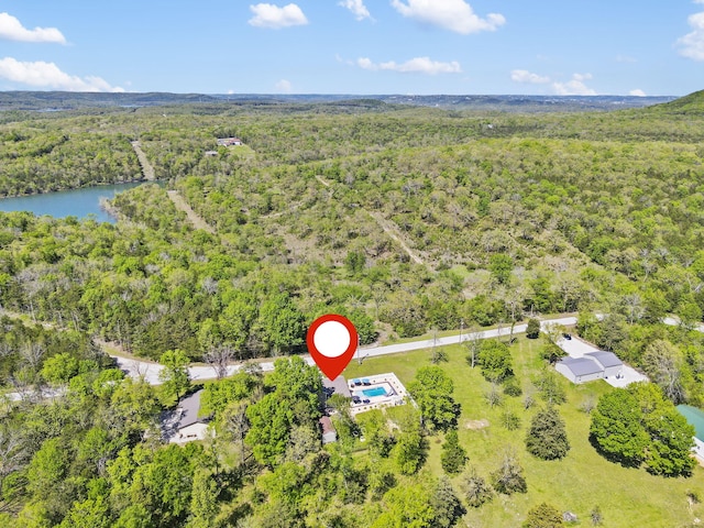 aerial view featuring a forest view and a water view