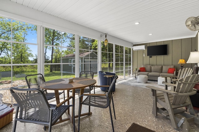 sunroom / solarium featuring outdoor dining area, plenty of natural light, and an AC wall unit