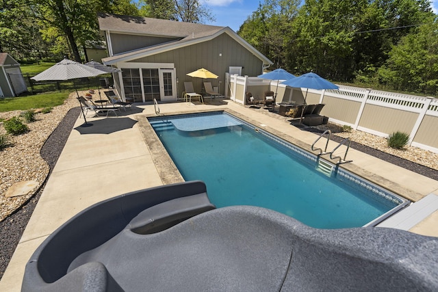 view of pool with a patio area, a fenced backyard, and a fenced in pool