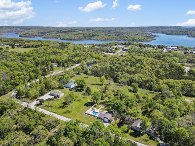 drone / aerial view featuring a forest view and a water view