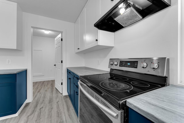 kitchen featuring blue cabinets, light wood-style flooring, white cabinetry, range hood, and electric stove