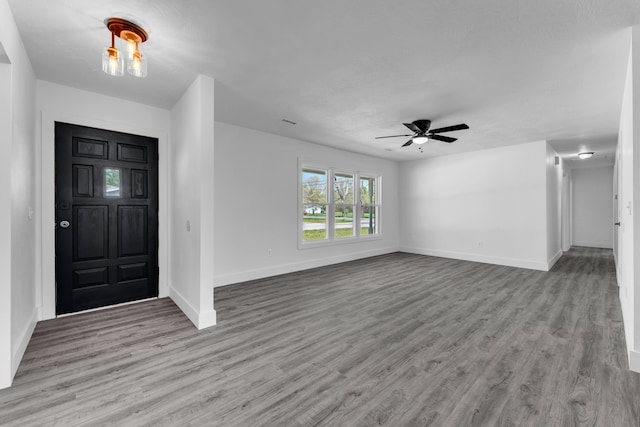 entryway featuring ceiling fan, baseboards, and wood finished floors