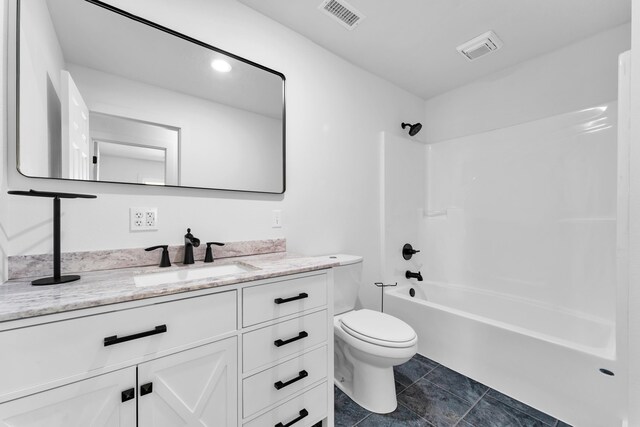 full bath featuring toilet, visible vents, vanity, and shower / washtub combination