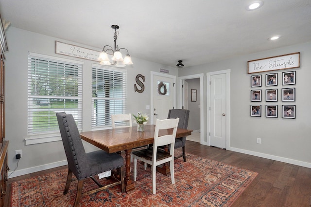 dining area featuring dark wood finished floors, baseboards, a chandelier, and recessed lighting