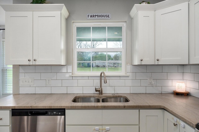 kitchen with dishwasher, white cabinetry, and a sink