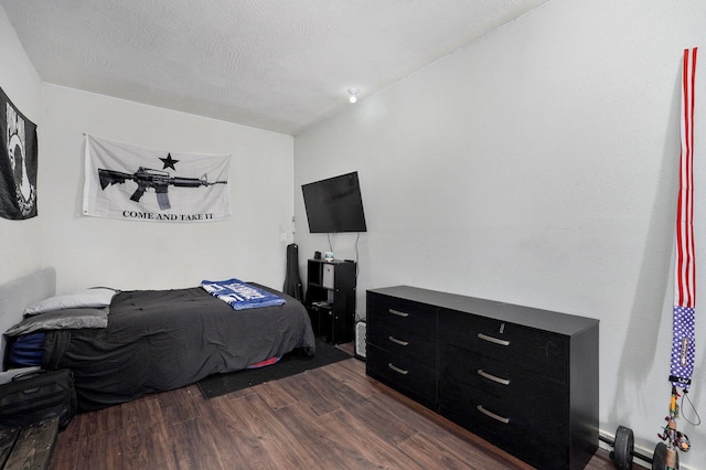 bedroom featuring dark wood-style flooring