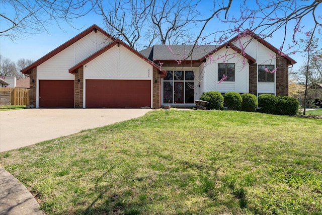 2236 E Marlan Ct, Springfield, MO 65802 - view of front facade with a front lawn, concrete driveway, fence, a garage, and brick siding