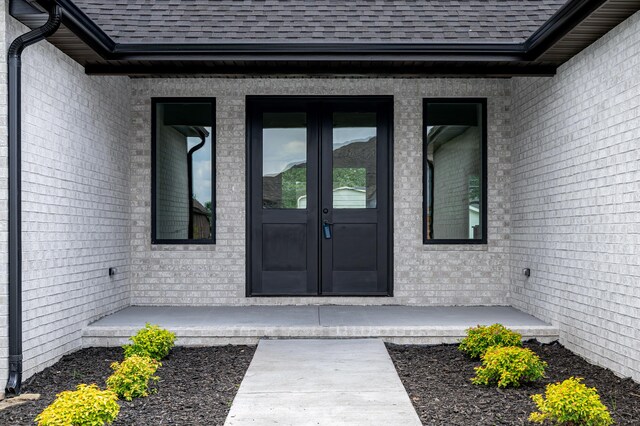 3800 W Broadmoor St, Springfield, MO 65807 - property entrance with french doors, roof with shingles, and brick siding
