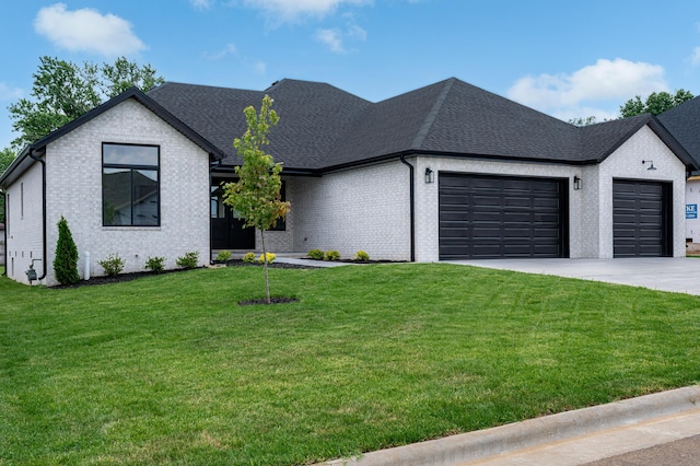 3800 W Broadmoor St, Springfield, MO 65807 - view of front facade featuring an attached garage, brick siding, concrete driveway, a front lawn, and roof with shingles