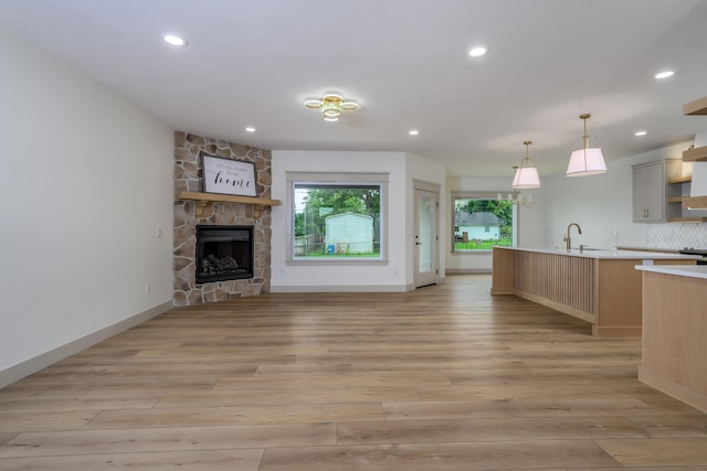 3800 W Broadmoor St, Springfield, MO 65807 - unfurnished living room with light wood-style floors, a fireplace, and recessed lighting