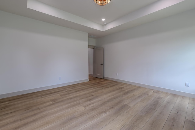 3800 W Broadmoor St, Springfield, MO 65807 - spare room with a tray ceiling, light wood-type flooring, and recessed lighting