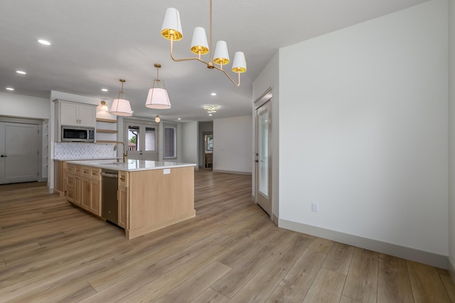 3800 W Broadmoor St, Springfield, MO 65807 - kitchen featuring stainless steel appliances, light countertops, light wood-type flooring, recessed lighting, and open floor plan