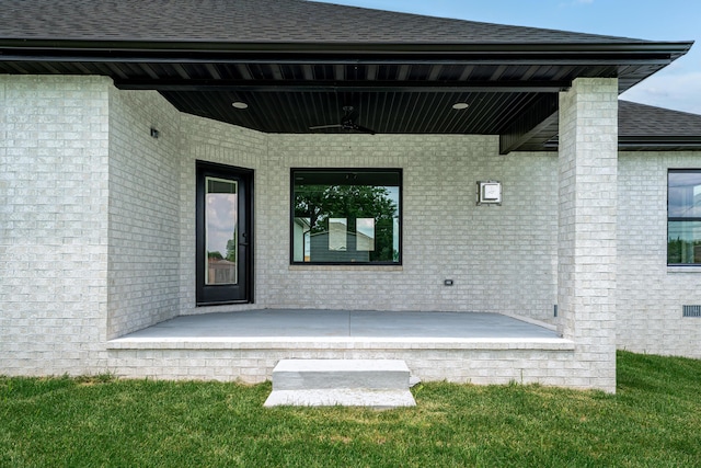 3800 W Broadmoor St, Springfield, MO 65807 - entrance to property featuring a porch, a ceiling fan, brick siding, and a lawn