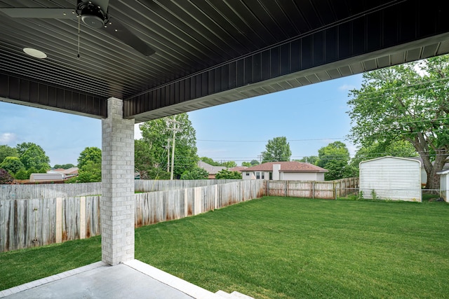 3800 W Broadmoor St, Springfield, MO 65807 - fenced backyard with ceiling fan, a patio, and a storage unit