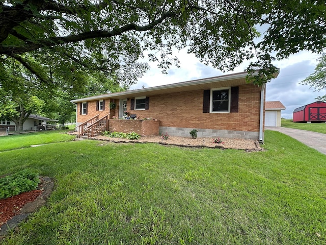 203 Roberts Dr, Mount Vernon, MO 65712 - ranch-style home featuring a front yard, driveway, brick siding, crawl space, and an outdoor structure