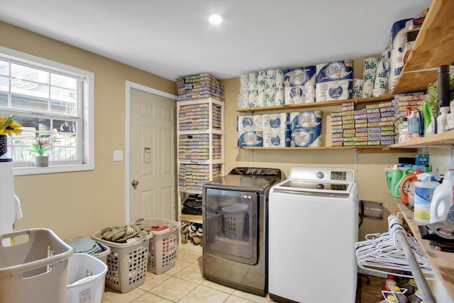 laundry area featuring light tile patterned floors, washer and dryer, and laundry area