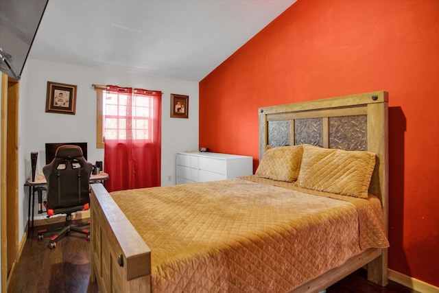 bedroom with wood finished floors, vaulted ceiling, and baseboards