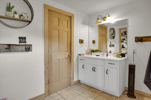bathroom with tile patterned floors, vanity, and baseboards