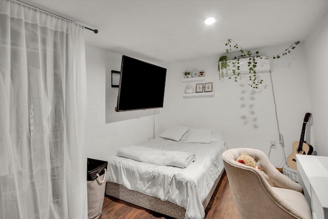 bedroom with wood finished floors and recessed lighting
