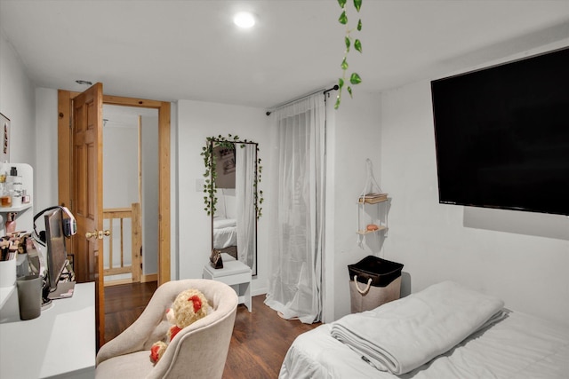 bedroom featuring wood finished floors and baseboards