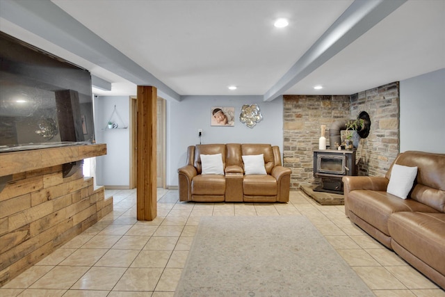living area with beamed ceiling, a wood stove, light tile patterned flooring, and recessed lighting