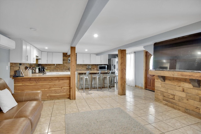 living room with recessed lighting, light tile patterned floors, and a wall mounted AC