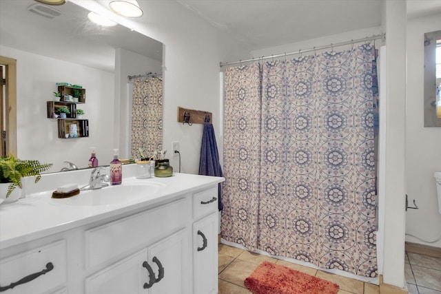 full bathroom with curtained shower, visible vents, tile patterned flooring, and vanity